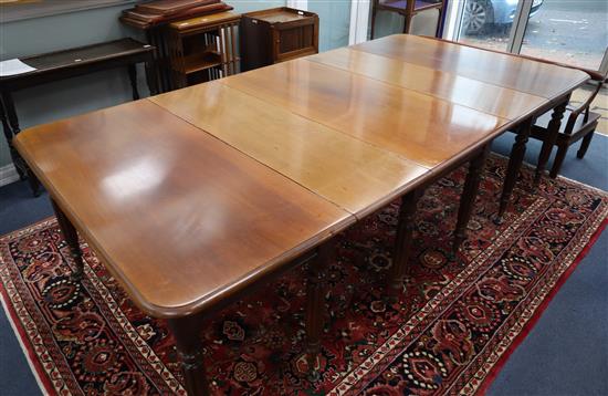 A mahogany extending dining table circa 1830s, centre section with drop leaves 252cm extended